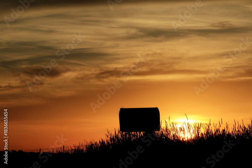 sunset in the countryside with a country mailbox