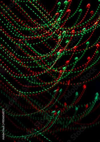Christmas themed nighttime light trail image of red and green led lights.