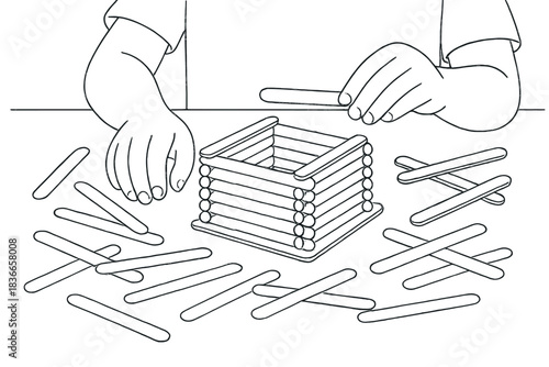 Creative Popsicle Stick Building. Child’s hands building a popsicle stick fort on tabletop with scattered sticks around, first in
