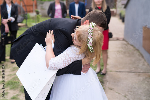 Emotional Hug during Family Celebration. Candid Family Moment	between father and daughter