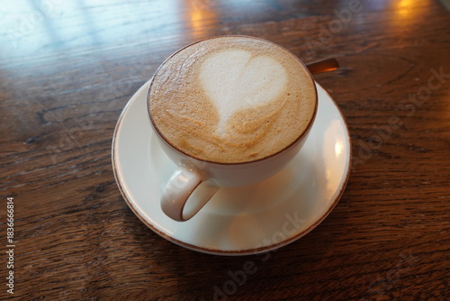 Latte art featuring a heart design served in a cozy cafe
