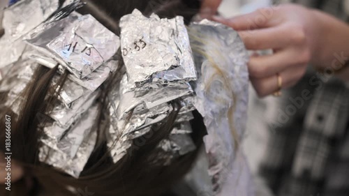 Colorist washes dye from hair to the sink
