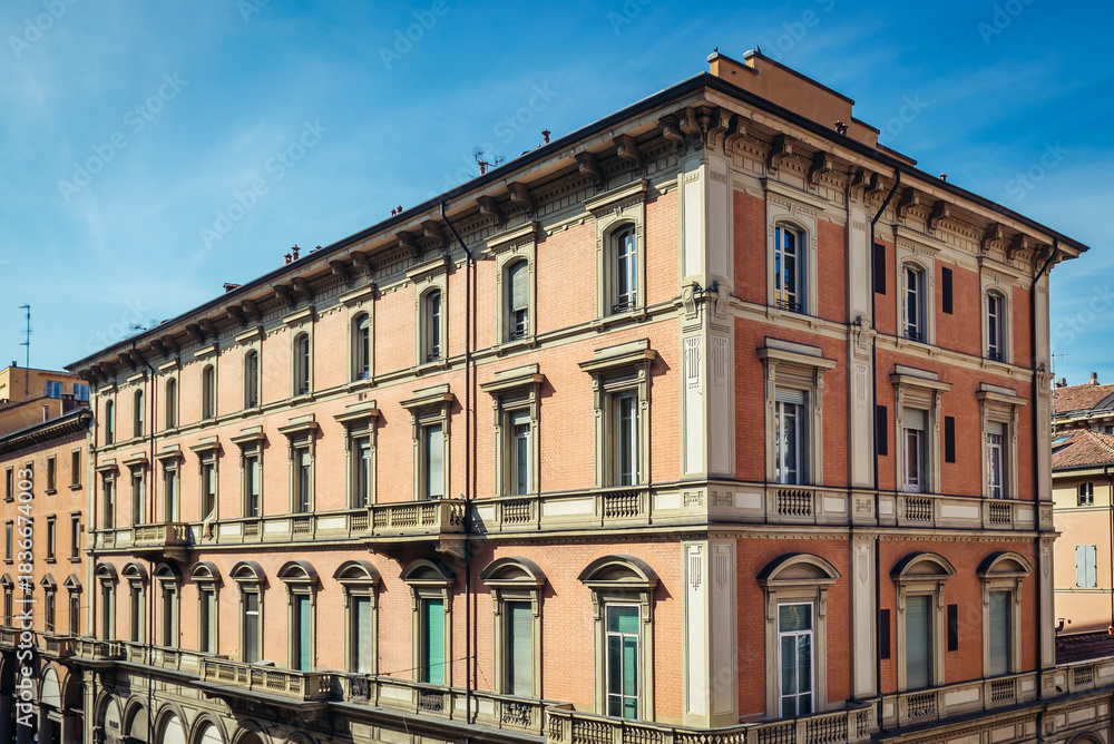 Fototapeta premium Tenement houses on Independence Street along wall of Montagnola Park in historic part of Bologna city, Italy