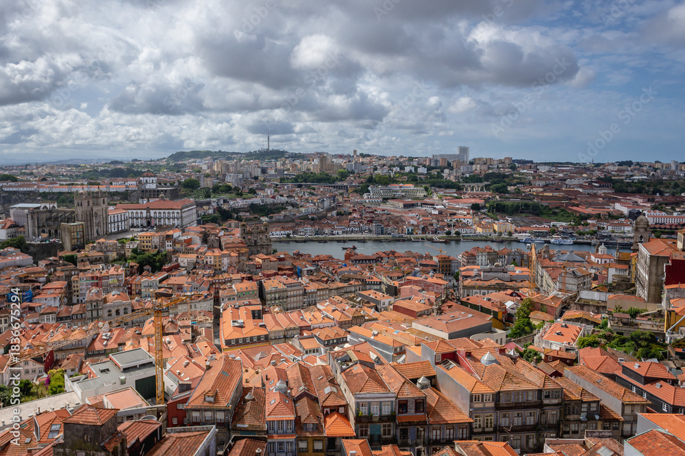Naklejka premium Aerial view from tower of Clerigos Church in Porto city, Portugal with Douro River and Vila Nova de Gaia city on background