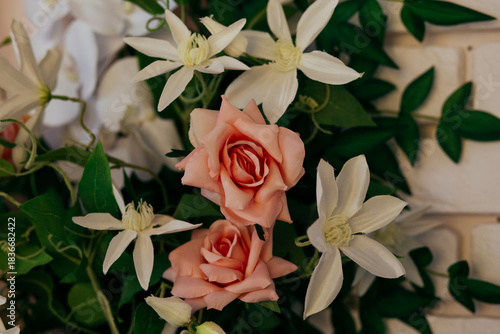 a floral arrangement made of environmentally friendly materials for the interior of a festive event, wedding, or presentation. A photo area with artificial roses