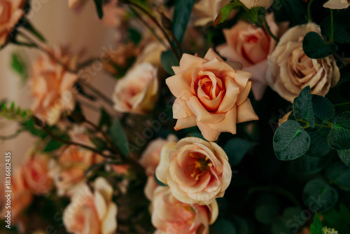a floral arrangement made of environmentally friendly materials for the interior of a festive event, wedding, or presentation. A photo area with artificial roses