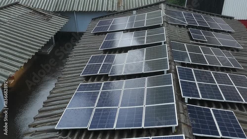 Solar panels being installed on a residential tiled roof for renewable energy generation.