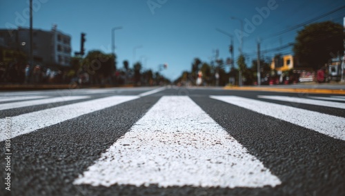 Close-up view of a pedestrian crossing on a clear day with city buildings in background