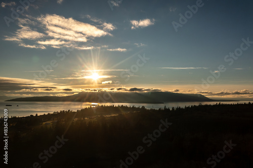 Aerial sunset view of a beautiful sunset behind Orcas Island, Washington. Orcas Island is the largest of the San Juan Islands of the Pacific Northwest, in northwestern Washington, United States.