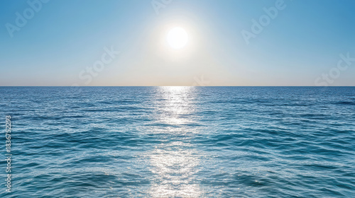 Fototapeta Naklejka Na Ścianę i Meble -  Sunlit ocean horizon glowing water calm sea reflecting sunlight at midday