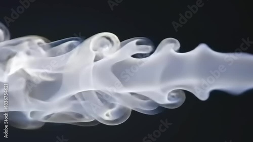 Abstract white smoke against black background.