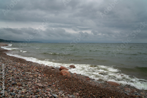 Fototapeta Naklejka Na Ścianę i Meble -  Baltic Sea and a pebble beach on a cloudy summer day, Svetlogorsk, Kaliningrad region, Russia