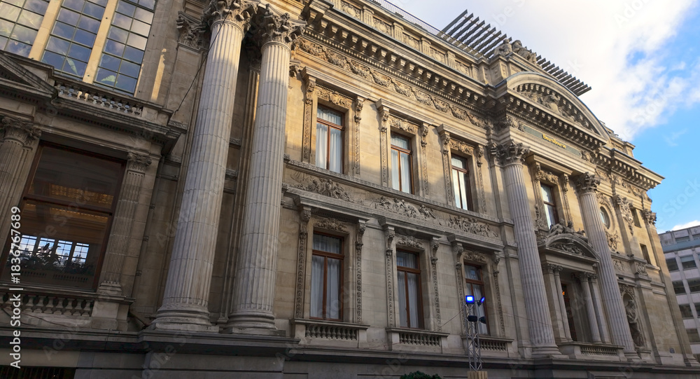 Naklejka premium BRUSSELS, BELGIUM - NOVEMBER 26, 2025 - Brussels Bourse, a historic landmark, featuring classical architecture and ornate stone carvings