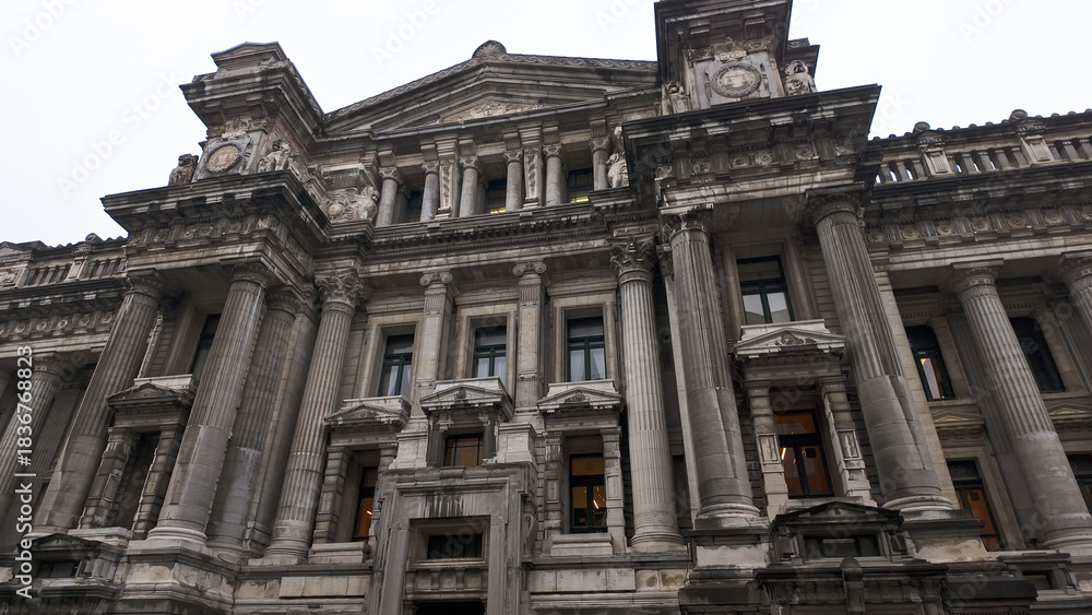 Naklejka premium BRUSSELS, BELGIUM - NOVEMBER 26, 2025 - Palace of Justice, a grand architectural landmark against an overcast sky