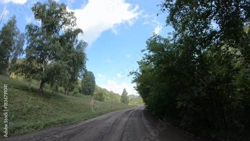 Video of driving in a car In summer season along country road in Altai region. Route from settlement Cherga to village Altaiskoe. Tractor on the road.