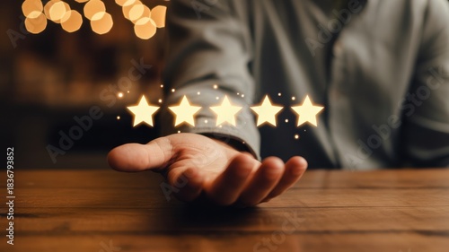Customer Satisfaction and Excellent: A person's hand with five stars floating above it on a wooden table, emphasizing excellence and customer satisfaction.
