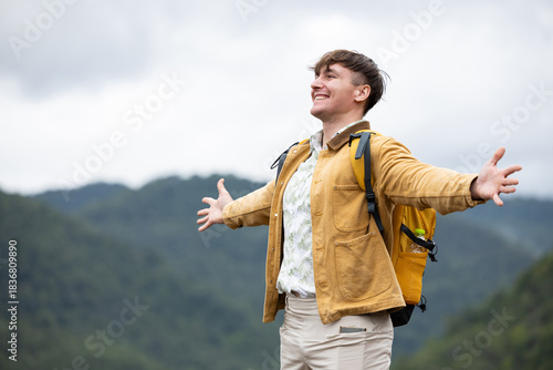 Man breathing deeply and embracing nature on eco trip