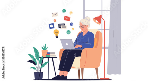 Modern senior woman sitting in an armchair and using a laptop to connect with family and friends through social media.