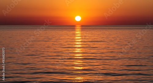 Scenic ocean vista capturing a radiant sunset, warm colors paint the water & horizon
