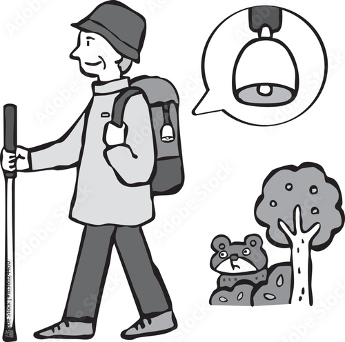 熊よけの鈴をつけて山登りをする男性（シニア）