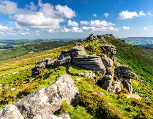 Scenic overview of rugged terrain with rocky formations under a vibrant blue sky with fluffy clouds