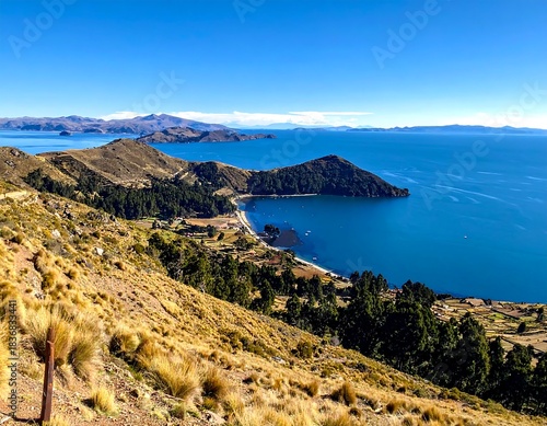 Scenic panorama of a vast lake with islands and surrounding arid hills under a clear sky