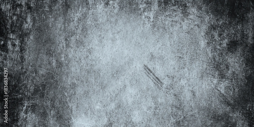 Dark moody grunge texture with scratches cracks and worn concrete surface black and white distressed background.