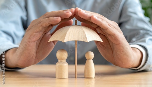 Obraz na plátně Two Wooden Figurines Protected Under a Miniature Umbrella Held by Hands Symboliz