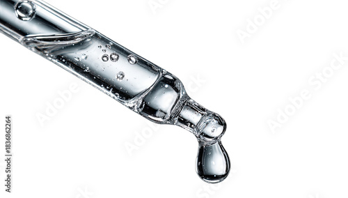 Clear liquid with bubbles drips from a glass pipette tip on black