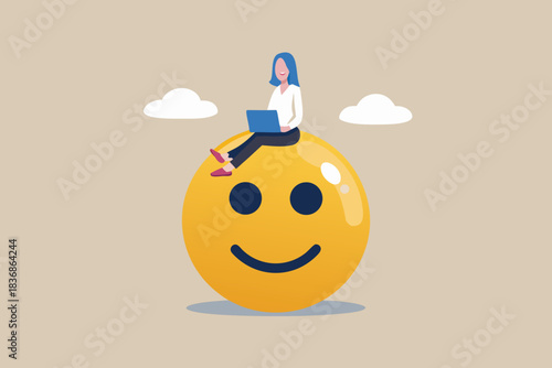 Woman working on laptop sitting on a big smiley face emoji