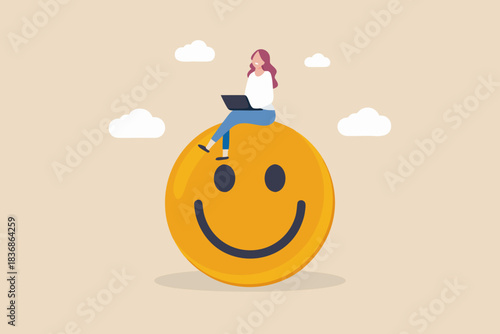 Happy freelancer working on laptop sitting on a giant smiley face icon