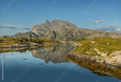 Tranquil lake mirroring the mountain behind in the north of Norway