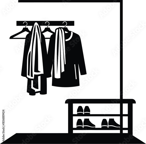 Black clothes rack with coats, hangers, and shoes for home organization