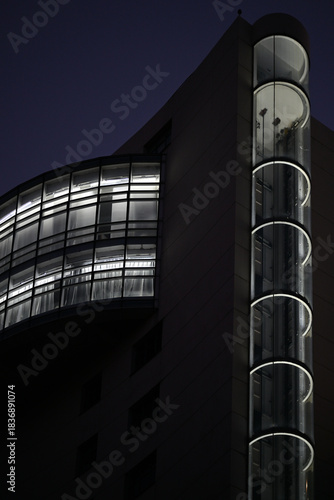 modern office building in night Elevator shaft covered with lights