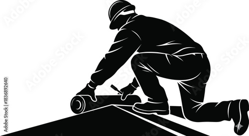 Roofing worker installing material on a house roof