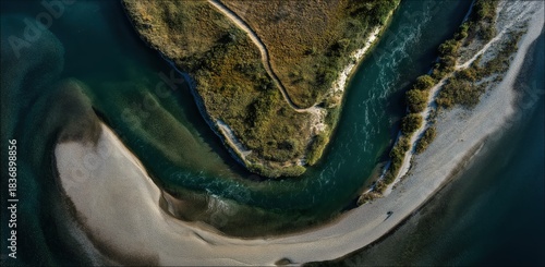 Fototapeta Naklejka Na Ścianę i Meble -  Aerial view of the river and land: An aerial perspective showcases the meandering path of a river as it gracefully carves through the land, revealing a dynamic interplay of textures and tones.