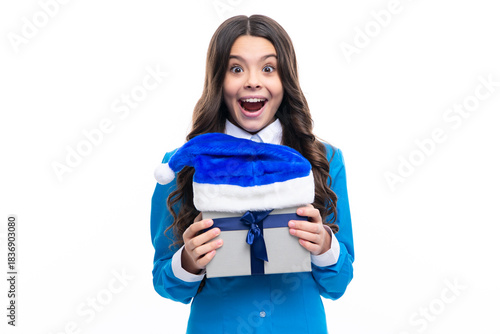 Excited kids face. Child with gift present box on isolated background. Presents for birthday, Valentines day, New Year or Christmas. Amazed expression, cheerful and glad.