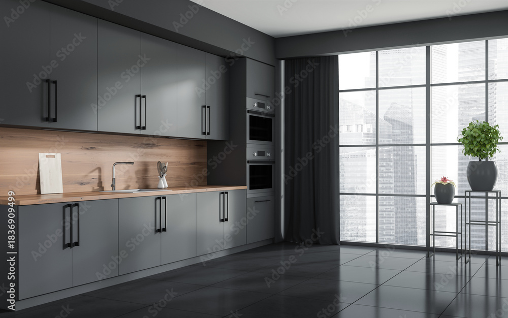 Fototapeta premium Sleek modern kitchen interior with matte grey cabinets, wooden backsplash, and city view through large windows, minimalist design concept. 3D Rendering