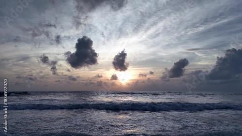 Aerial view of sunset at ocean scene with vibrant skies and reflections on the water