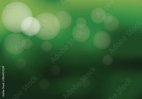 Softly blurred green background with bokeh lights creating a serene and tranquil abstract natural ambiance
