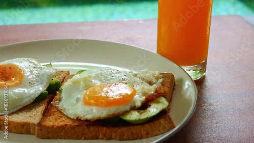Soft sunlight fills cozy kitchen spreading warmth and serenity around Breakfast with fresh orange juice embodies healthy lifestyle gentle comfort and harmony of healthy balance in peaceful home