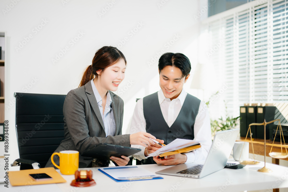Fototapeta premium Professional female lawyers consulting on legal cases in a modern office. Perfect for law, business, justice, and teamwork