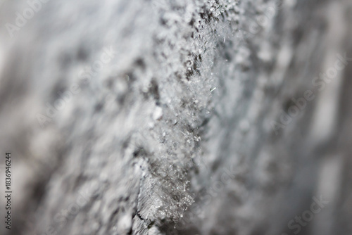 Tableau sur toile Macro shot of needle-like efflorescence crystals growing on a damp, textured con