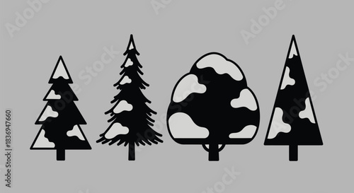 Snowy forest trees in black and white silhouette