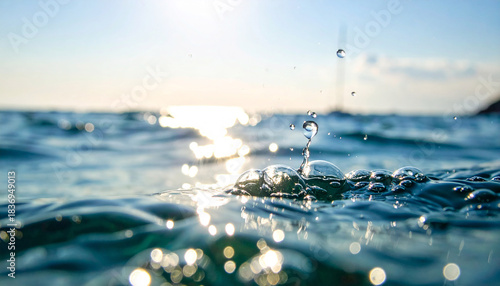 Fototapeta Naklejka Na Ścianę i Meble -  Close up of ocean water surface with sunlit ripples and rising bubbles image photo