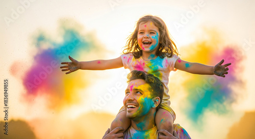 father playing colors with daughter celebrating holi festival