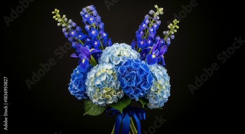 Radiant Bouquet: A captivating arrangement of blue hydrangeas and elegant delphiniums, bursting with vibrant hues against a dark background.