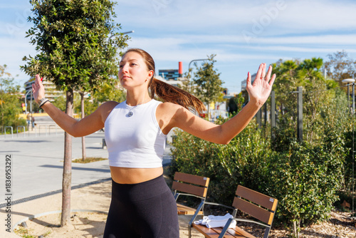 Принти на полотні Woman performing dynamic burpees on green lawn in park with activewear capturing