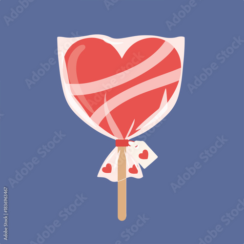 A red heart-shaped lollipop wrapped in clear plastic with a gift tag.