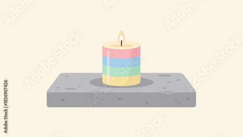 A colorful striped candle burning brightly on a gray holder.